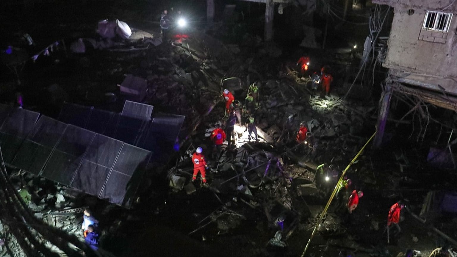 Lebanese Red Cross volunteers search for possible victims in a building destroyed by an Israeli strike in the southern port city of Sidon, Lebanon, early Tuesday, Jan. 6, 2026