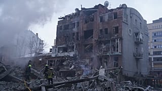 Emergency services personnel work to extinguish a fire following a Russian missile attack in Kharkiv, Ukraine, Friday, Jan. 2, 2026.