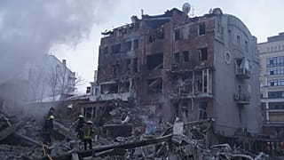 Emergency services personnel work to extinguish a fire following a Russian missile attack in Kharkiv, 2 January, 2026