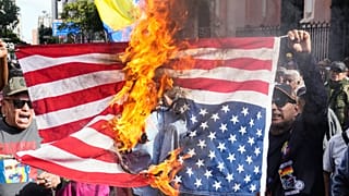 Government supporters burn a US flag after Trump announced that US forces had captured Venezuelan President Maduro and his wife, in Caracas, Venezuela, Saturday, Jan. 3, 2026