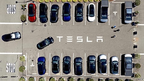 FILE - Tesla vehicles line a parking area at the company's Fremont, Calif., factory, Aug. 5, 2025.