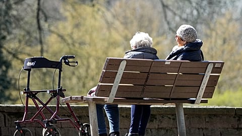 480x270_cmsv2_a742e909-dad1-5767-8296-0b3f9370d57d-9601877 FILE. Elderly women sit on a bench beside their walker in the sun at a park in Gelsenkirchen, Germany,