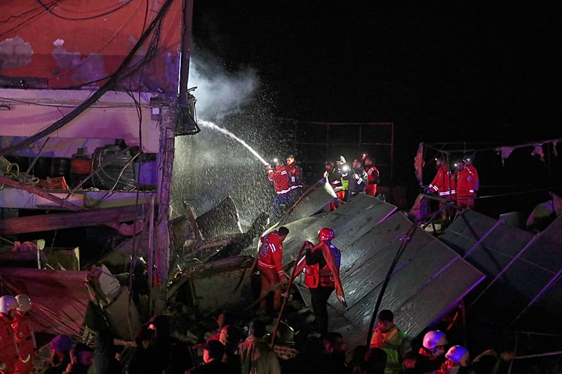 Lebanese fire fighter extinguish a building destroyed by an Israeli airstrike in the southern port city of Sidon, Lebanon, early Tuesday, Jan. 6, 2026