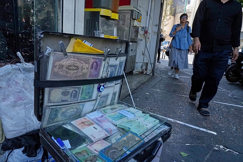 Iranian banknotes are displayed by a street money exchanger in downtown Tehran, 28 August, 2025