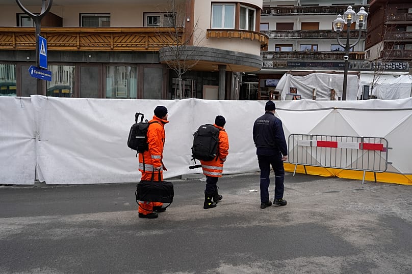 Experts arrive at the sealed off Le Constellation bar in Crans-Montana, Swiss Alps, Switzerland, Friday, Jan. 2, 2026.