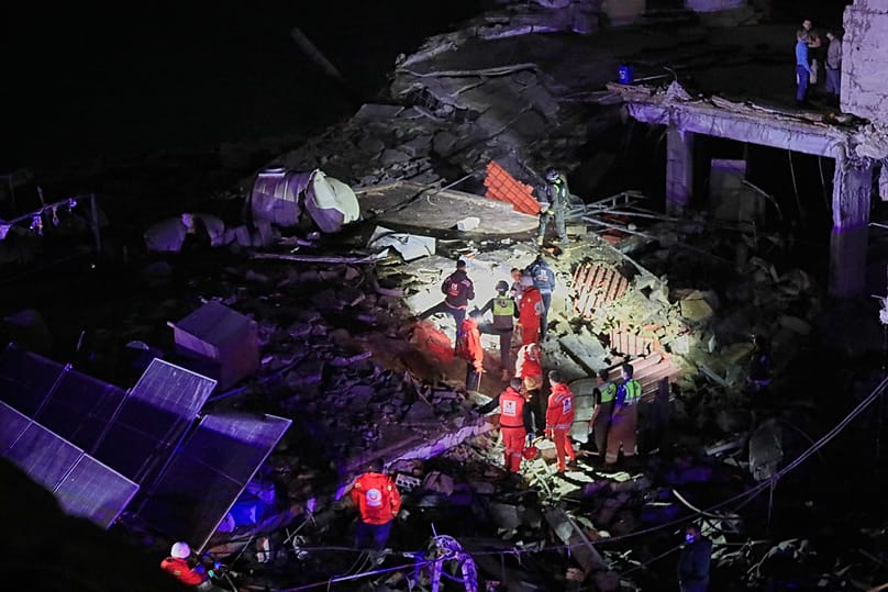 Rescue workers search for possible victims in a building destroyed by an Israeli airstrike in the southern port city of Sidon, Lebanon, early Tuesday, Jan. 6, 2026