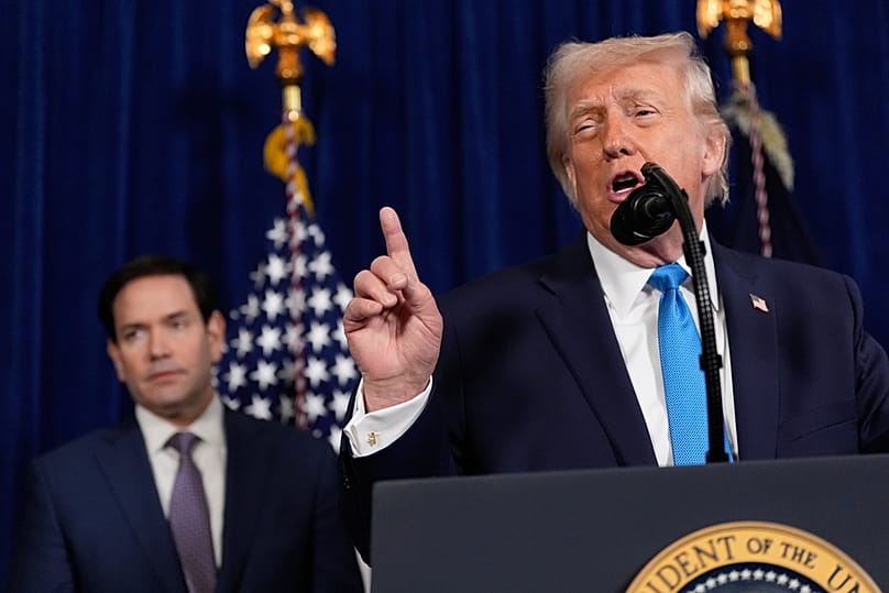 President Donald Trump speaks during a news conference at Mar-a-Lago, Saturday, 3 Jan, 2026, in Palm Beach, Fla., as Secretary of State Marco Rubio listens.