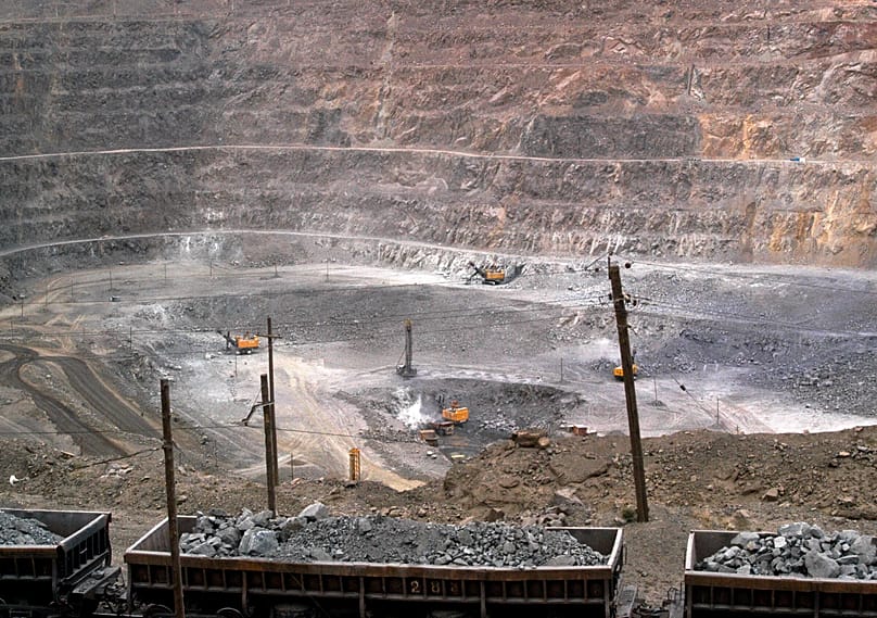 Workers use machinery to dig at a rare earth mine in Baiyunebo mining district of Baotou, 6 July, 2010
